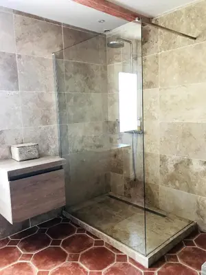 a bathroom with a shower with a glass door at Les Pagnons in Velleron