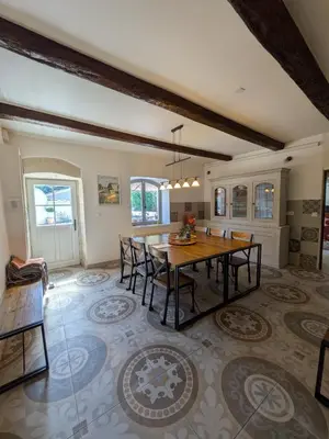 a large dining room with a table and chairs at Les Pagnons in Velleron