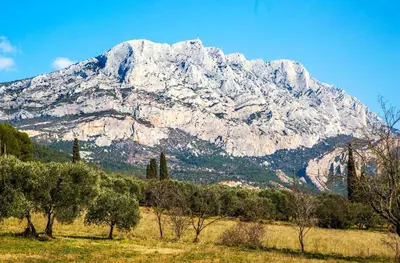 a snow covered mountain with trees in front of it at le Signoret in Aix-en-Provence