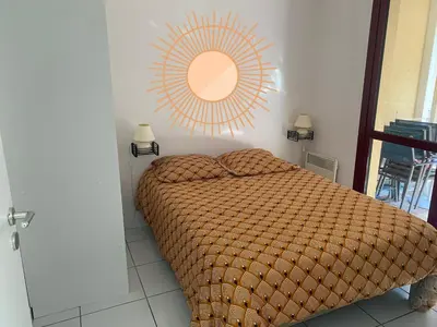 a bedroom with a bed with a large orange comforter at le Signoret in Aix-en-Provence