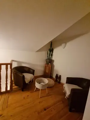 a living room with two couches and a table at ENTRE VENTOUX ET LUBERON Chambre d'hôte in Sault-de-Vaucluse