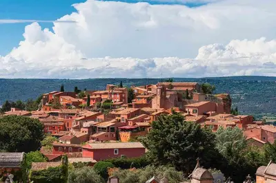 a village on top of a hill with houses at ENTRE VENTOUX ET LUBERON Chambre d'hôte in Sault-de-Vaucluse