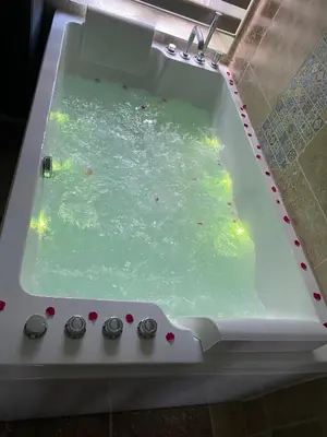 a bath tub filled with green water in a room at Chambre d'hôtes Alizé, Le Moulin de Prédelles in Reillanne