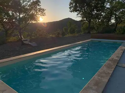 a swimming pool with the sunset in the background at Provencal farmhous Lubéron, swimming pool in Revest-des-Brousses