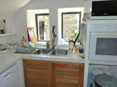 a kitchen with a sink and a microwave at Provencal farmhous Lubéron, swimming pool in Revest-des-Brousses