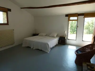 a bedroom with a white bed and two windows at Provencal farmhous Lubéron, swimming pool in Revest-des-Brousses