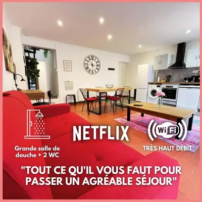 a living room with a red couch and a table at Spacieux appartement T4 / 70 m2 8 personnes in Aix-en-Provence
