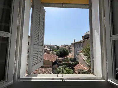 an open window with a view of a city at Spacieux appartement T4 / 70 m2 8 personnes in Aix-en-Provence