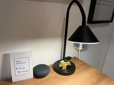 a black lamp and a clock on a wooden table at Spacieux appartement T4 / 70 m2 8 personnes in Aix-en-Provence