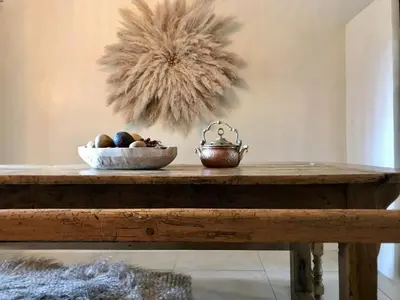 a wooden table with a bowl of fruit on it at Maison en pierre avec piscine, 6 couchages, située au cœur de Mallemort, Provence. - FR-1-658-25 in Mallemort
