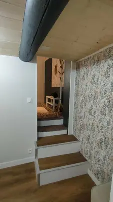 a staircase in a room with a wall with a wallpaper at Studio rénové maison de village du Luberon in Villelaure