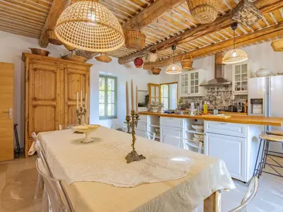 a kitchen with a table and chairs in a room at Holiday Home Le Mas de Marius by Interhome in Cavaillon