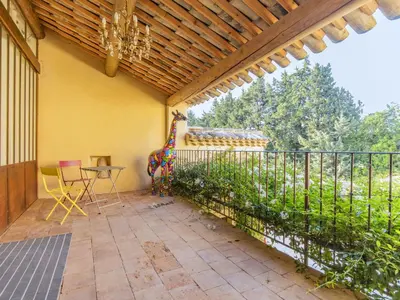 a patio with a fence and a table and chairs at Holiday Home Le Mas de Marius by Interhome in Cavaillon
