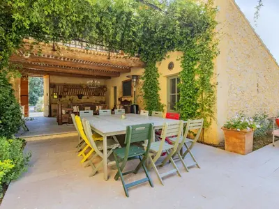 a table and chairs in front of a building at Holiday Home Le Mas de Marius by Interhome in Cavaillon