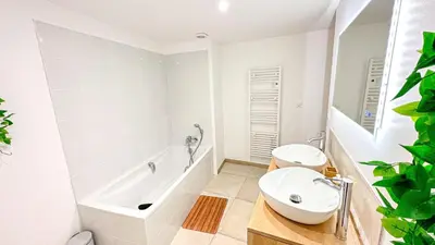 a bathroom with a tub and a toilet and a sink at Les Iris in Céreste