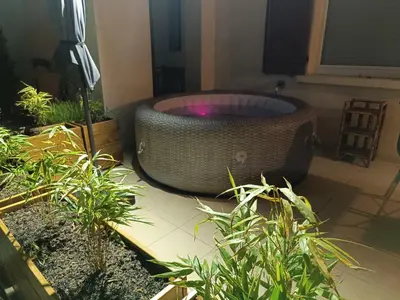 a large bath tub in a room with plants at Écrin de nature sous les pins in Aurons