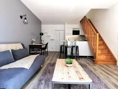 a living room with a couch and a table at Les quatres loges in Aix-en-Provence