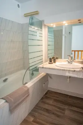 a bathroom with a tub and a sink and a shower at Les quatres loges in Aix-en-Provence