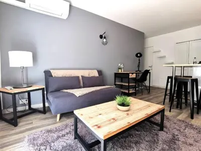 a living room with a couch and a table at Les quatres loges in Aix-en-Provence