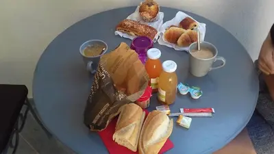 a blue table with breakfast foods and drinks on it at Une Parenthese pour Deux in Plan-dʼOrgon