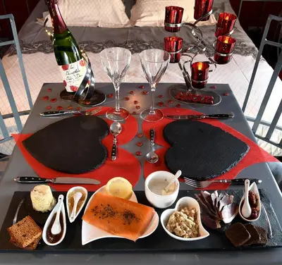 a table with a plate of food and a bottle of wine at Une Parenthese pour Deux in Plan-dʼOrgon