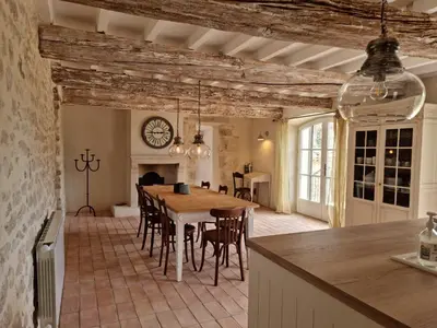 a kitchen and dining room with a table and chairs at Mas Cerisiers in Saint-Martin-de-Castillon