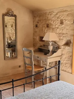 a bedroom with a desk and a chair and a mirror at Mas Cerisiers in Saint-Martin-de-Castillon