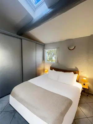 a bedroom with a large bed with a waterfall mural at Le Zenith - Calme absolu, jardin et piscine en Provence in LʼIsle-sur-la-Sorgue