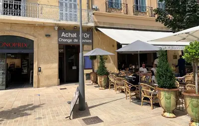 a group of people sitting at an outdoor restaurant at Appartement de Luxe ,