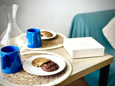 a table with two plates of cookies and blue cups at Studio le Méditerranée in Aix-en-Provence