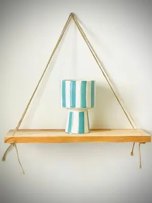 a wooden shelf with a blue and white vase on it at Studio le Méditerranée in Aix-en-Provence