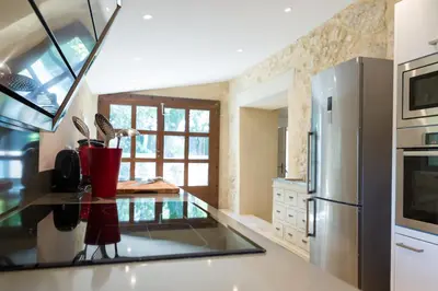 a kitchen with a stainless steel refrigerator and a counter at Château La Croix Des Pins in Mazan