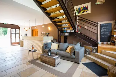 a living room with a couch and a staircase at Château La Croix Des Pins in Mazan