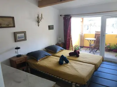 a bedroom with two beds with shoes on them at Appartement avec terrasse. in Apt