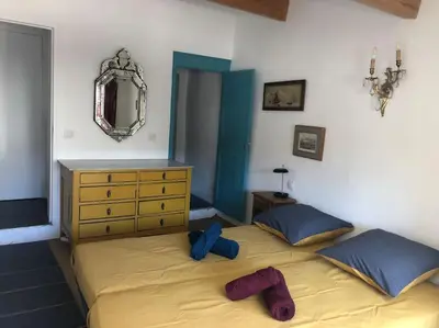 a bedroom with a bed and a dresser and a mirror at Appartement avec terrasse. in Apt