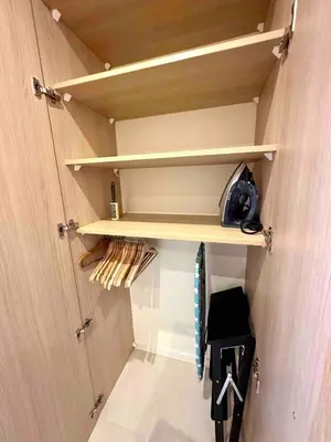 a walk in closet with wooden shelves at Centre ville AIX - Terrasse / Ascenseur - Rénové in Aix-en-Provence