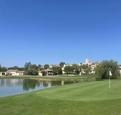 a view of a golf course with a lake at LES CISTES in Mallemort
