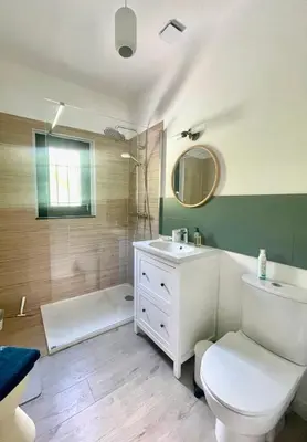 a bathroom with a white toilet and a sink at LES CISTES in Mallemort