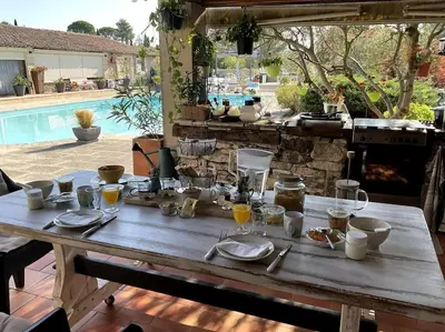 a wooden table with food and drinks on it at Chambre d'hôtes chez Maguy B-Villa Makeire in Gordes