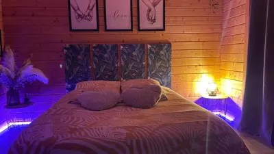 a bedroom with a bed with two pillows on it at Une Pause Douceur - Suite All in Wood in Eyguières