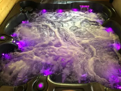 a pot of boiling water with purple lights in it at Une Pause Douceur - Suite All in Wood in Eyguières