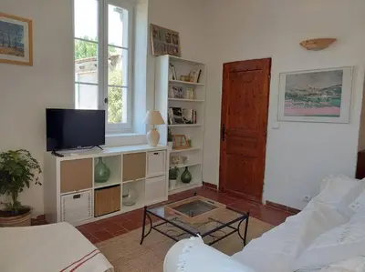 a living room with a couch and a tv at Maison de César in Saint-Saturnin-les-Apt