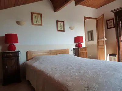 a bedroom with a bed and two lamps on the wall at Les Tournesols in Saint-Andiol