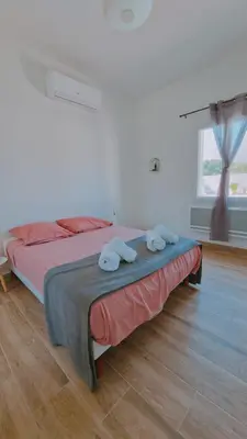 a bedroom with a bed with two towels on it at La perle du sud in Carpentras