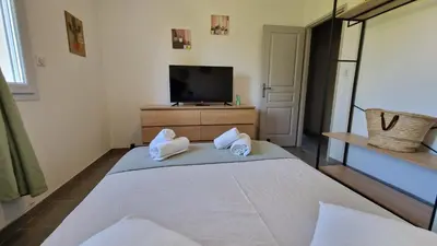 a bedroom with a bed with towels on it at La perle du sud in Carpentras