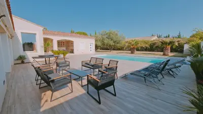 a patio with chairs and tables and a swimming pool at La perle du sud in Carpentras