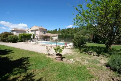 a house with a swimming pool in a yard at mas attached to another building with private pool 4 people in carpentras, at the foot of the ventoux in provence. in Carpentras