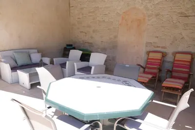 a room with chairs and a table and a group of tables and chairs at mas attached to another building with private pool 4 people in carpentras, at the foot of the ventoux in provence. in Carpentras
