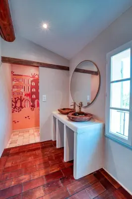 a bathroom with a sink and a mirror at Le Domaine du Printemps in Monteux