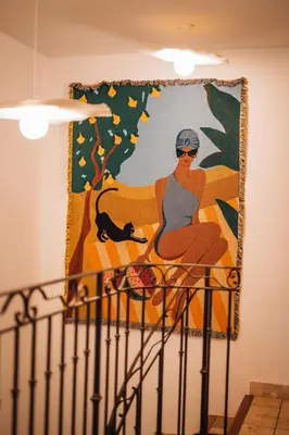a painting of a woman and a cat on a wall at Le Domaine du Printemps in Monteux